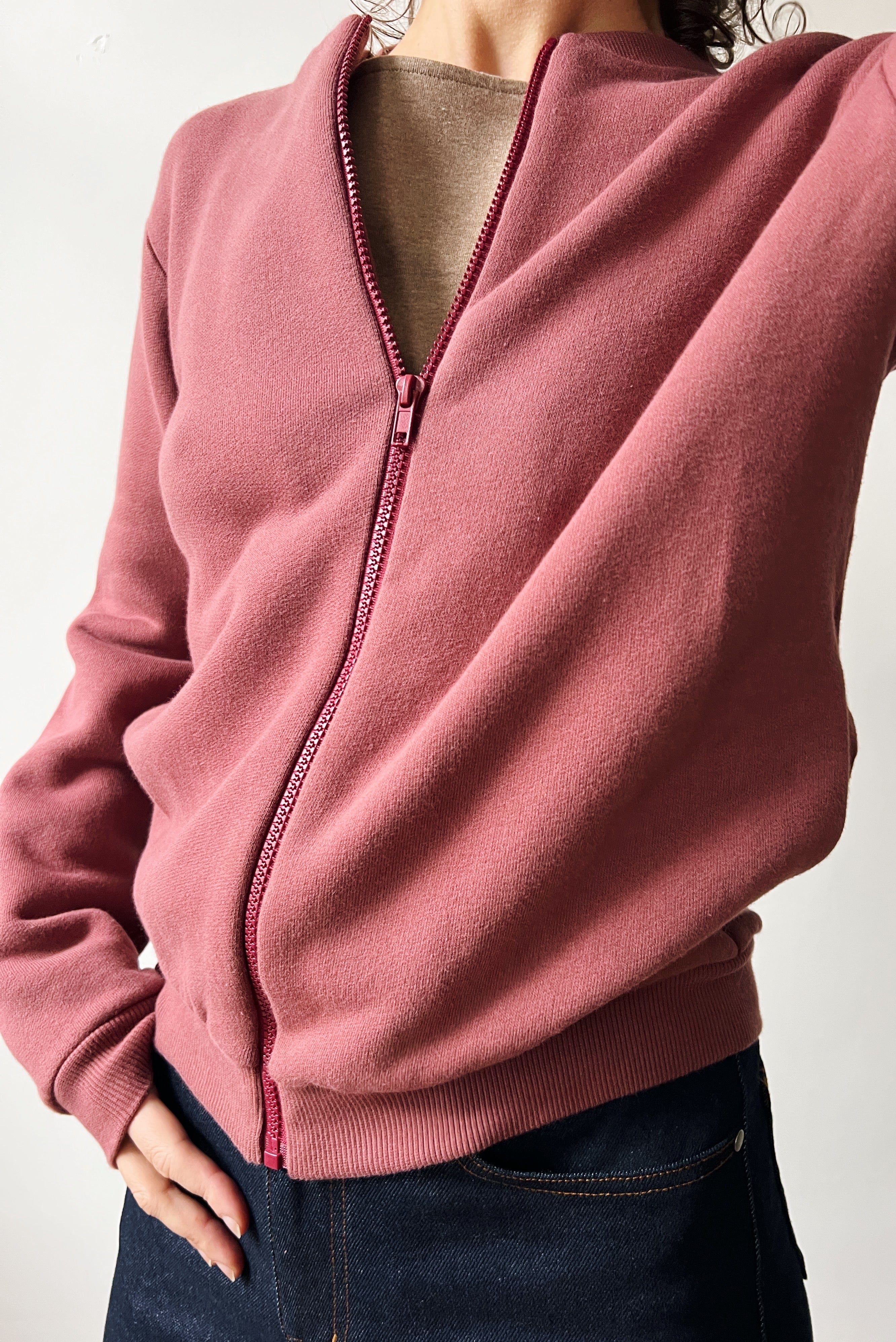 Figue zip-up bomber worn by a person on a plain background