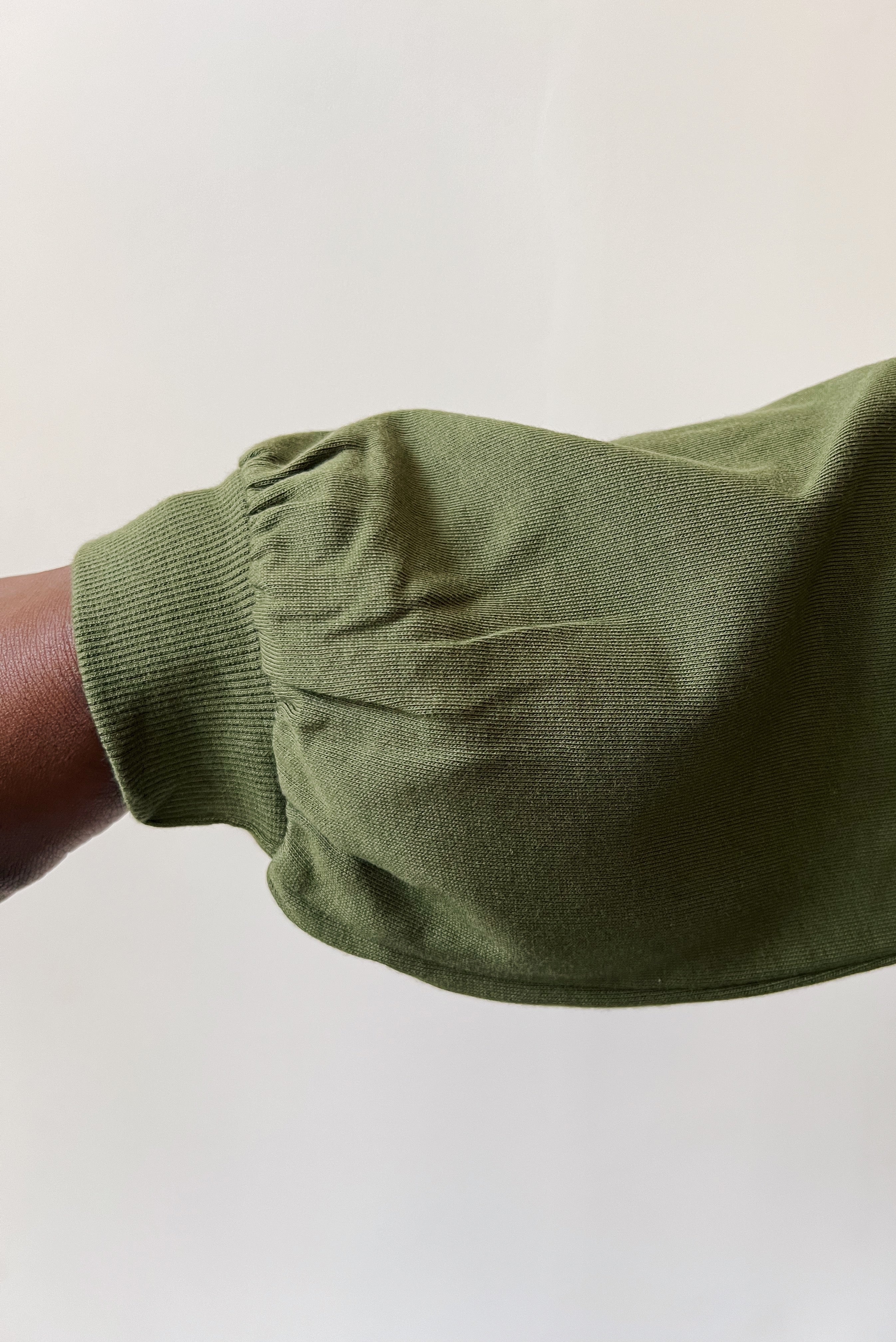 Round neck sweater with dropped shoulder seam, puffed sleeves and an oversized fit.