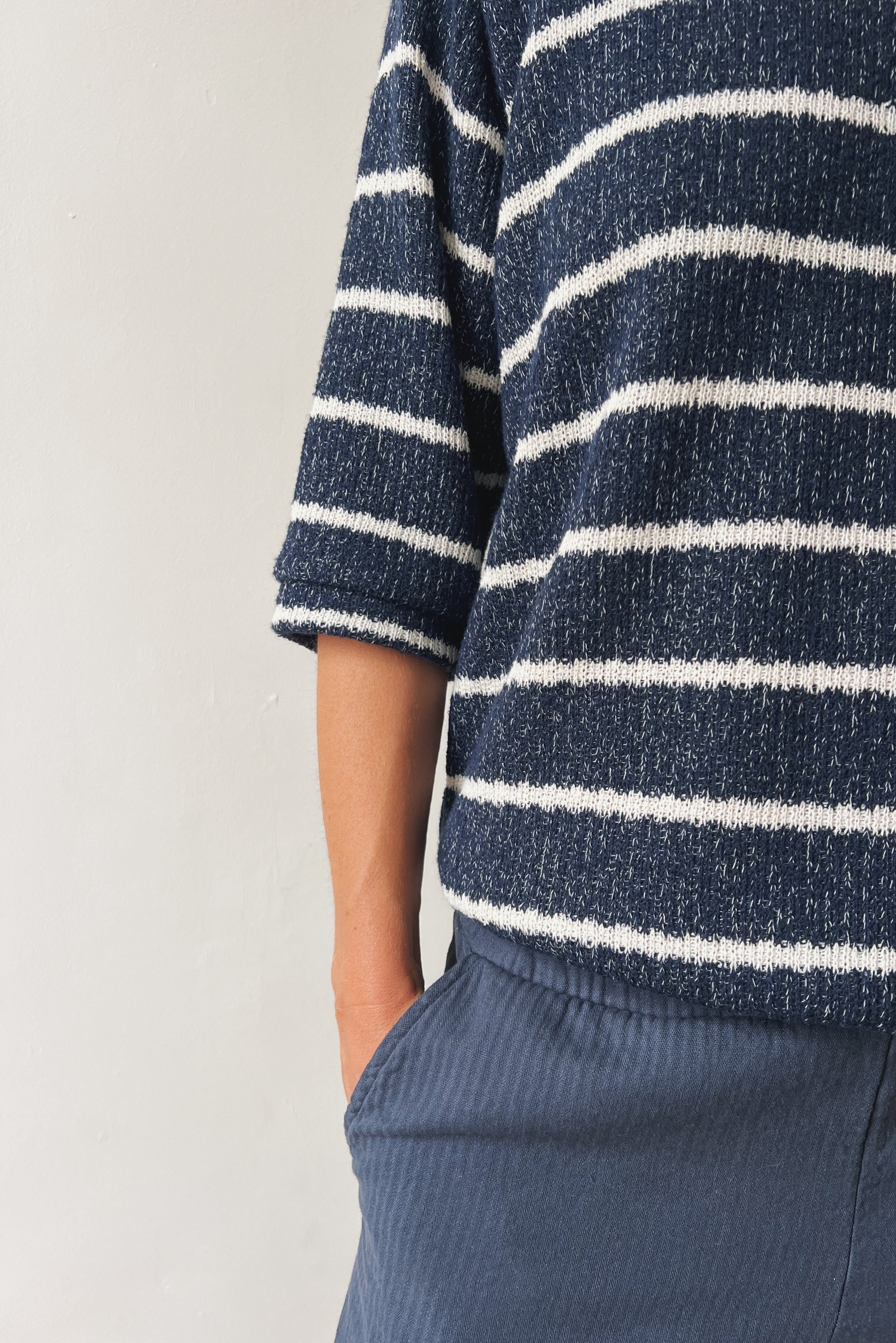 Woman wearing a blue-white striped midsleeve sweater