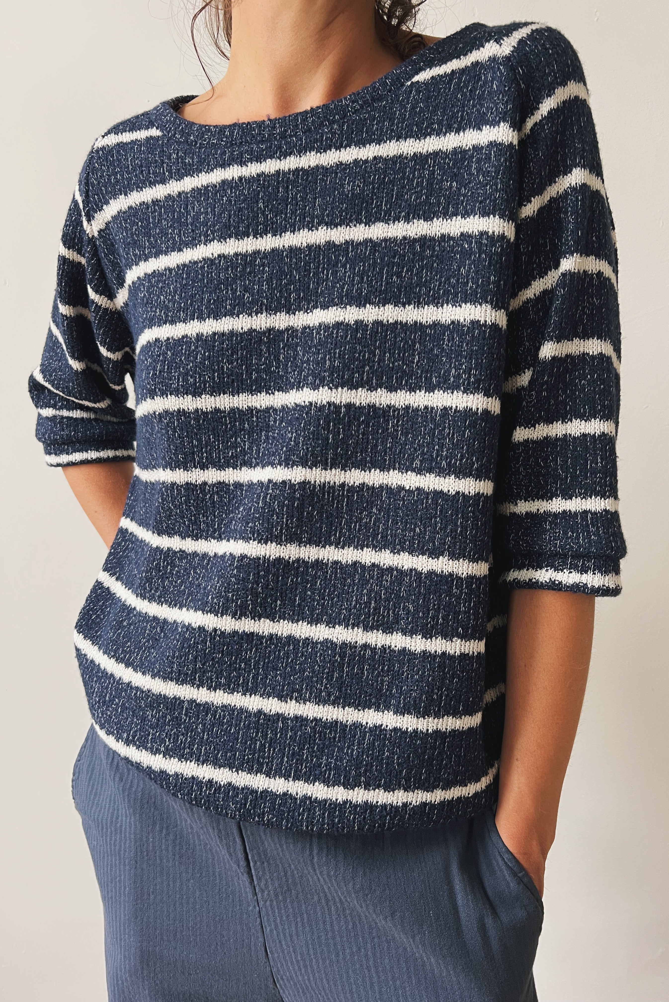 Woman wearing a blue-white striped midsleeve sweater