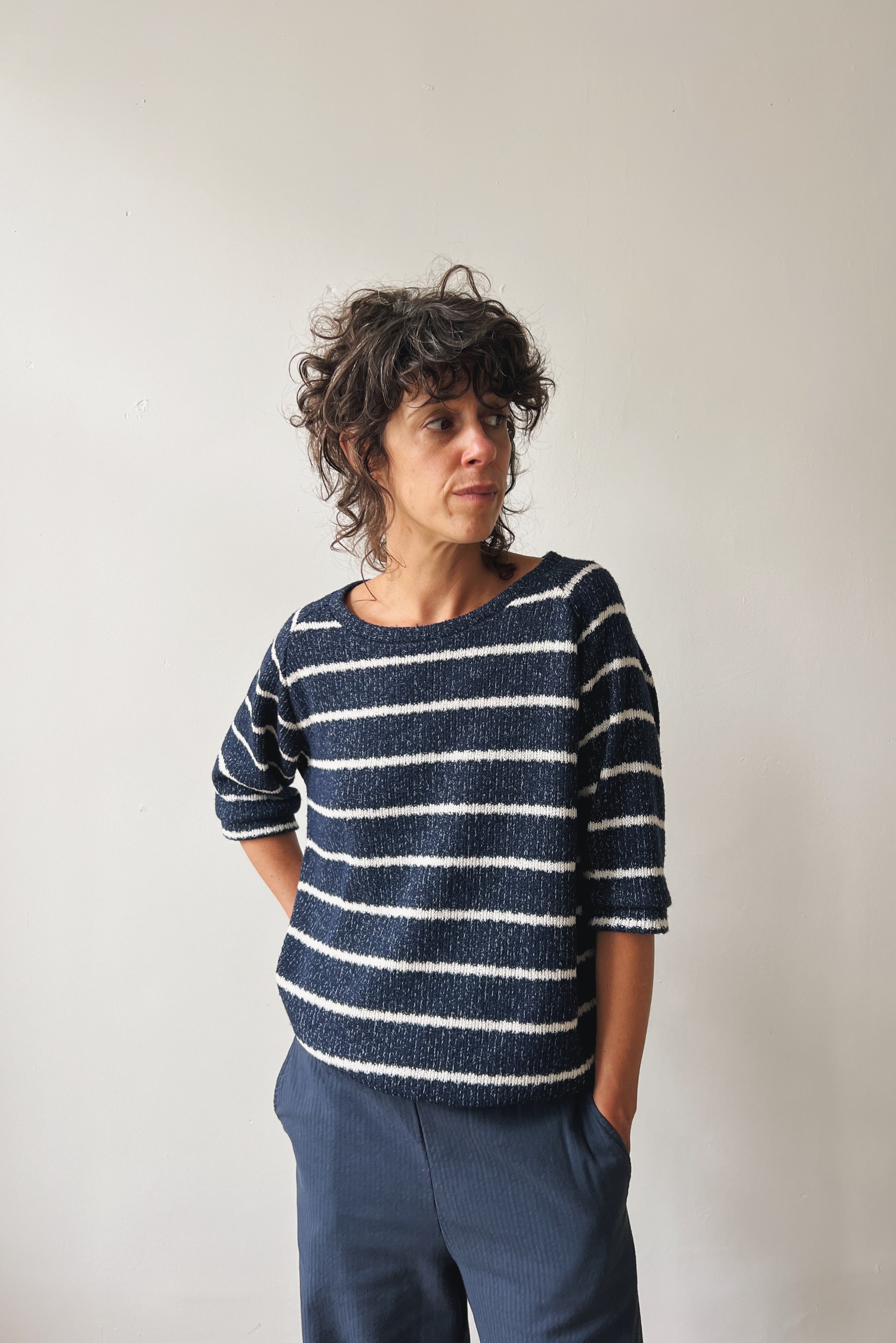 Woman wearing a blue-white striped midsleeve sweater