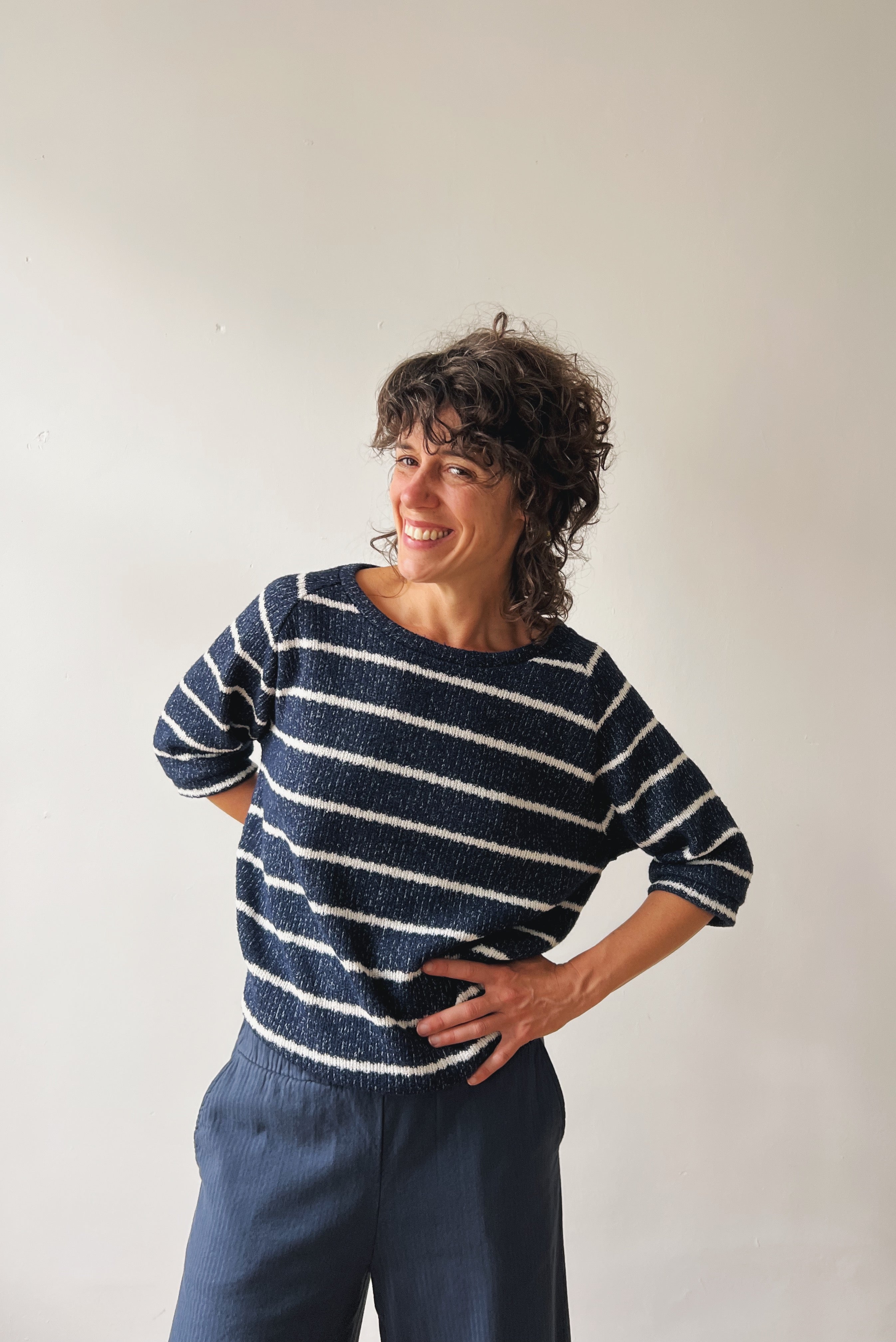 Woman wearing a blue-white striped midsleeve sweater