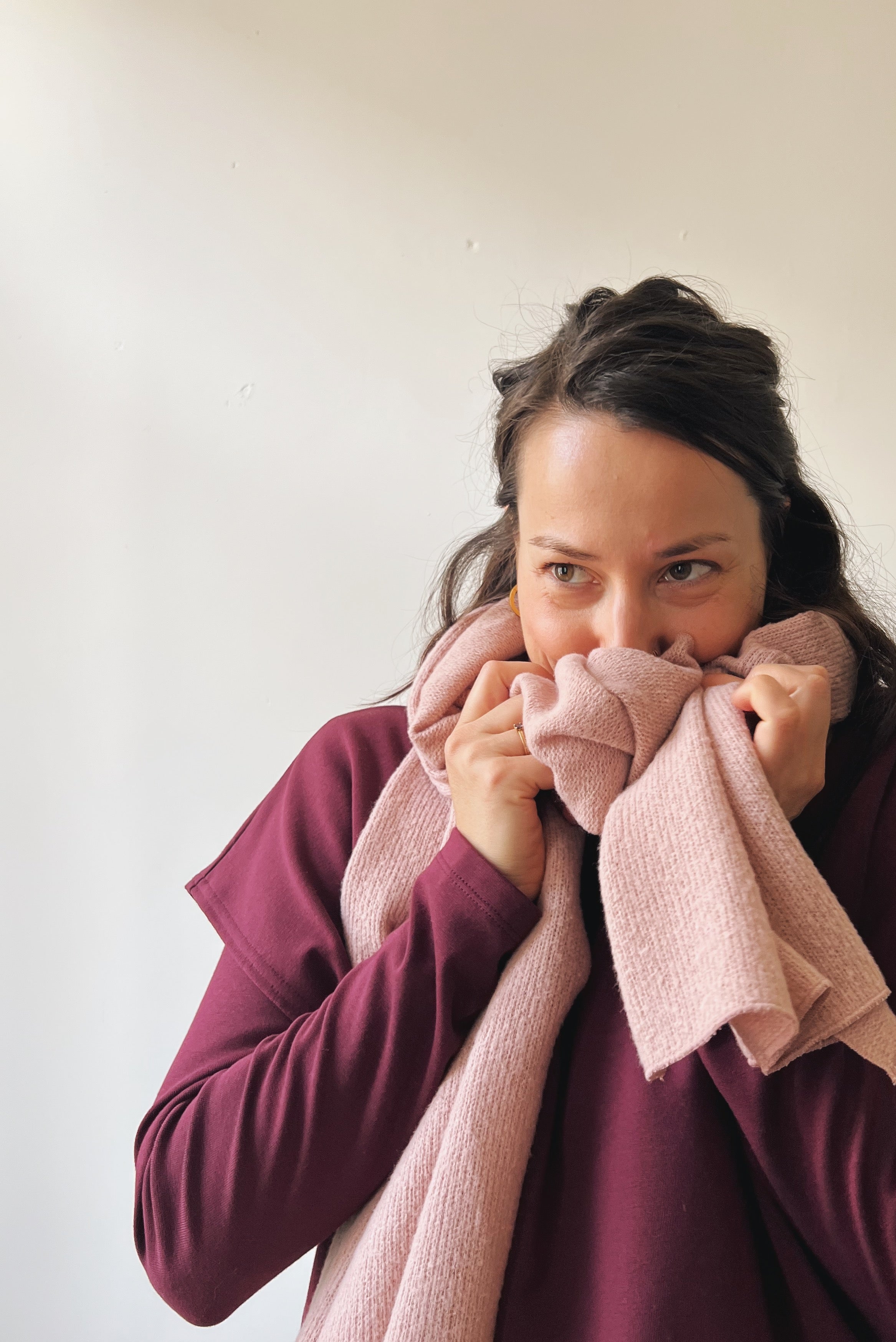Woman wearing a soft pink scarf 