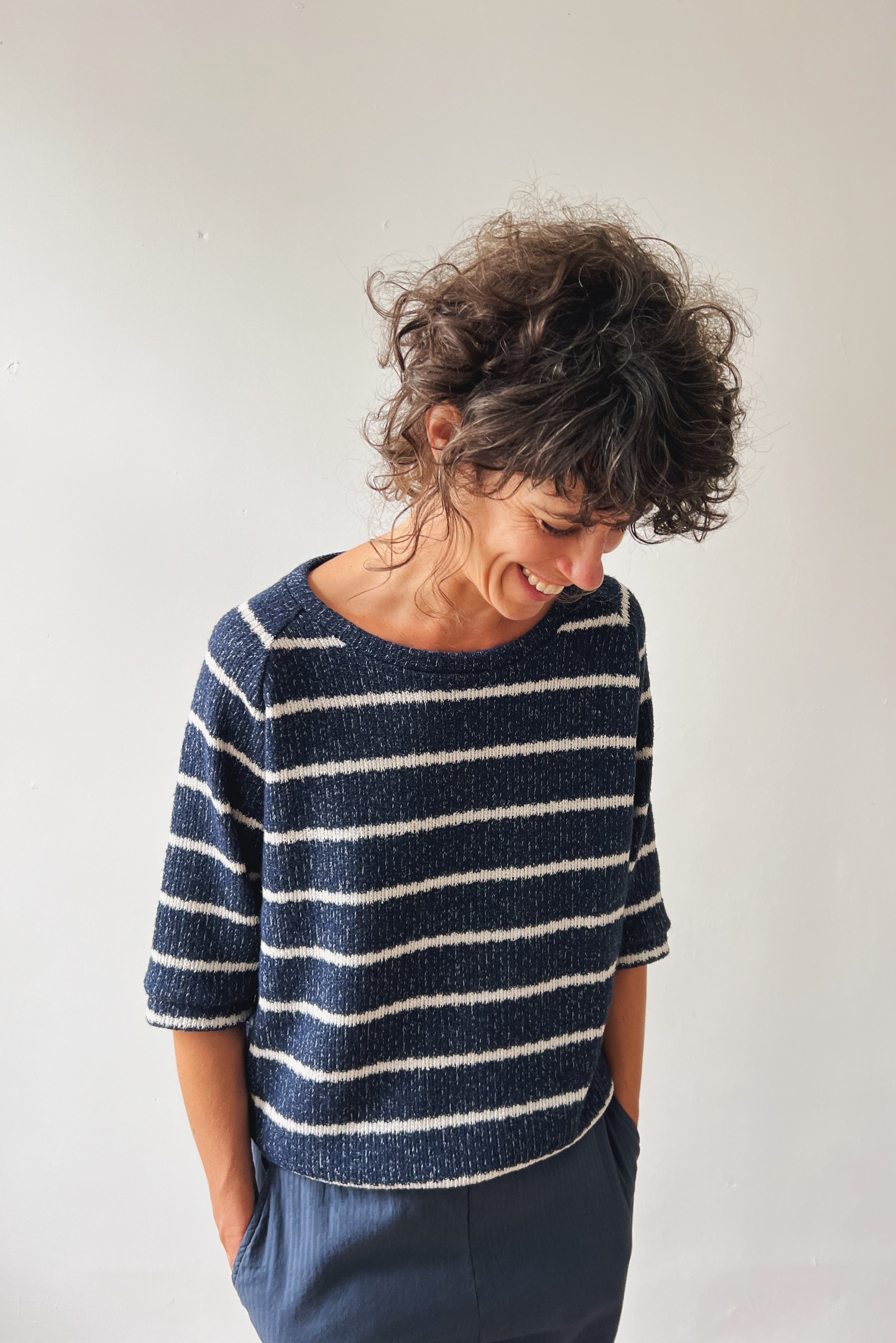 Woman wearing a blue-white striped midsleeve sweater